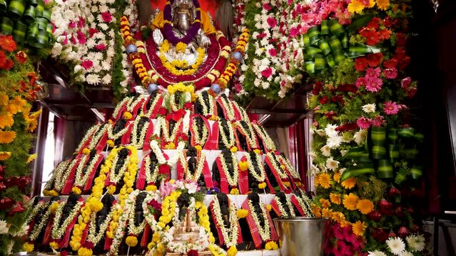 A Bewitching view of a Collection of Lord Ganesha idols decorated with colorful flowers during Ganesh Chaturthi religious festival celebrated across India.
