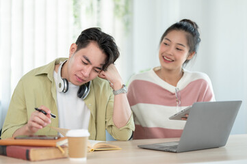 Obraz premium A friendly and kind Asian female friend is helping her friend with math lessons at home.