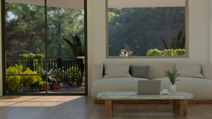 Interior design of a modern minimalist home living room with a balcony with green garden.