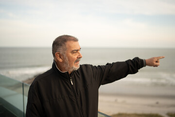 Happy Mature Man Enjoying Beach Lifestyle by the Ocean