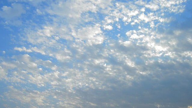 Cloudy blue sky background, horizontal video. Beautiful blue sky with tiny and soft fluffy clouds after raining. Elegant cloudy blue sky wallpaper background. Landscape image. Texture background.
