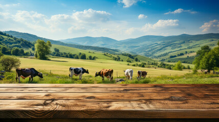 Wooden table top with grass field and cows in the background