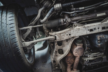 Close-up of car front suspension system components. - obrazy, fototapety, plakaty