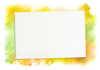 秋色の手描きパステルの背景と、白いスケッチブック