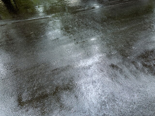 top view of wet asphalt road after rain. dark road with a reflection of overcast sky. - 653543109