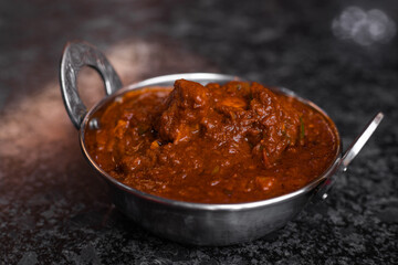 Chicken tikka masala spicy curry meat food Butter chicken on dark background close-up