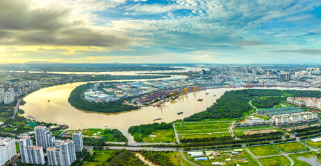 Top view aerial of a Ho Chi Minh City with development buildings, transportation, energy power infrastructure on a winter day. Cityscape on Saigon river in Ho Chi Minh City, Vietnam