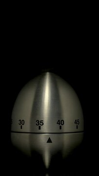 Time lapse of a kitchen clock timer countdown to zero.