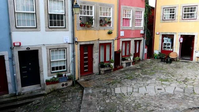 Iconic colorful houses on cobbled street in Largo da Pena Ventosa in Porto city centre