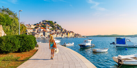 one person walking along the sea with boats,  town of Sibenik- travel, tourism in Croatia- Europa