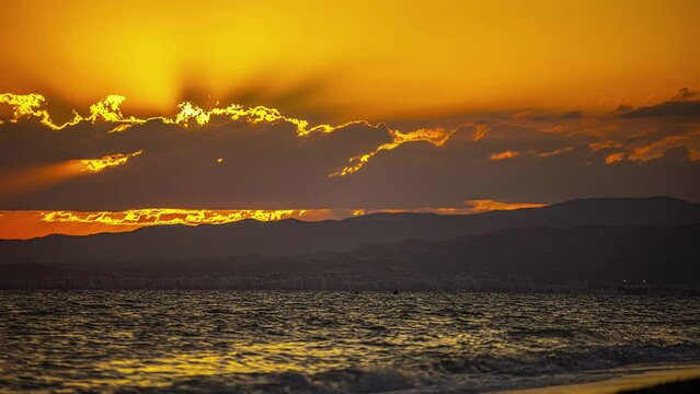 An orange-red sunset in Malaga at Playa de Torrox.