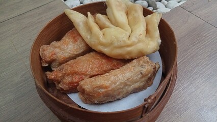 Dimsum is a unique food from Hong Kong which contains shrimp, fish or meat. which is served on a wooden bowl 