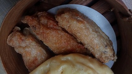 Dimsum is a unique food from Hong Kong which contains shrimp, fish or meat. which is served on a wooden bowl 