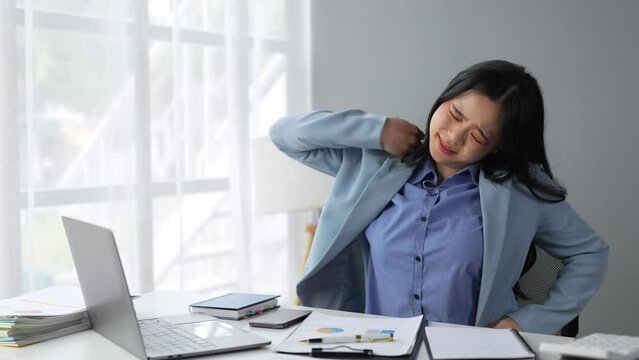 Attractive Asian business woman Relax from work after sitting for a long time. in order not to exceed the office syndrome at the office