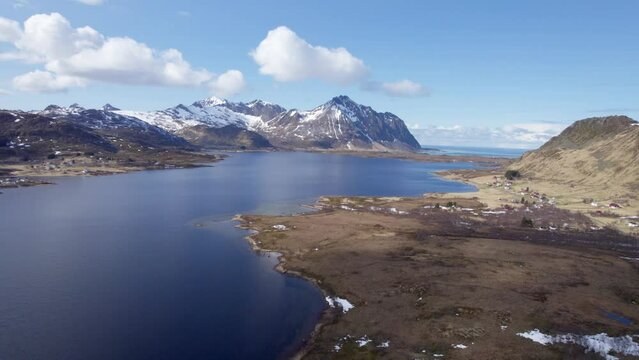 Aerial forwarding shot of snow capped Mountains on the Lofoten Islands during late winter near Borg