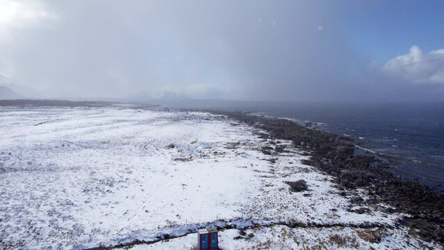 Aerial forwarding shot towards a snow storm during the winter in Northern Norway along the Norwegian coast