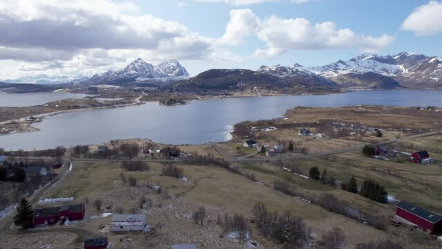 Aerial dolly shot of the historical Viking village borg in Lofoten, Northern Norway, partly cloudy and sunny