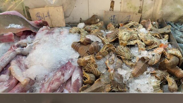Fresh raw seafood of prawns, crayfishes and cuttlefishes sold in Singapore Chinatown Market.