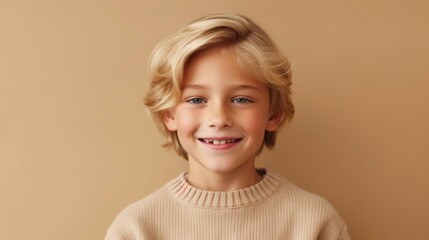 A cute little boy with golden locks showcases his infectious happiness in a softly lit beige studio.