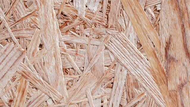 Chipboard plywood, surface rotating, turning, close-up macro, top view
