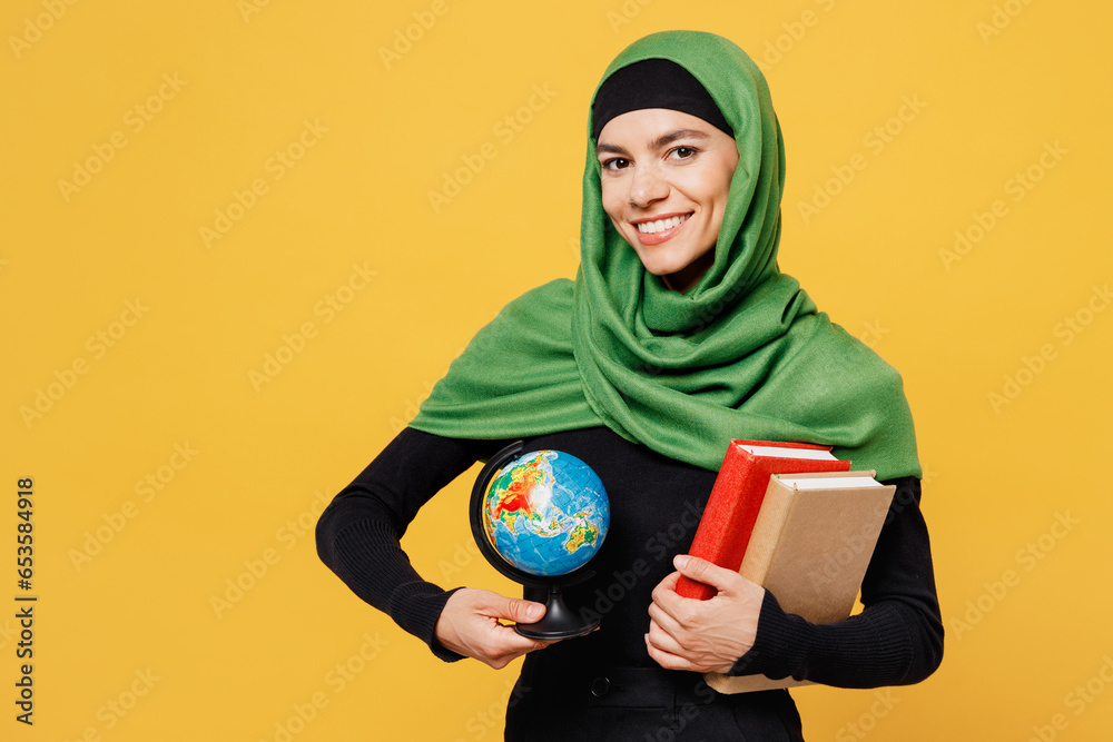 Wall mural young happy arabian asian muslim woman wear green hijab abaya black clothes hold in hand books earth