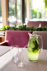 
cucumber lemonade standing on the table in a jug, hot summer day, soft drinks. quench your thirst,...