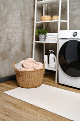Fototapeta na wymiar Washing machine in a gray modern laundry room