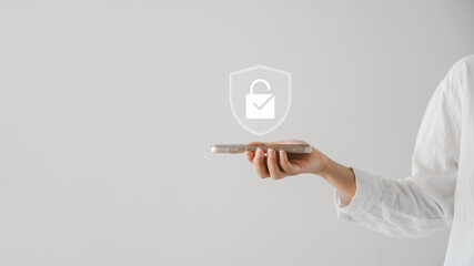 Cyber ​​security concept, business woman holding smartphone. Showing padlock icon, cyber security system, internet network security technology, protecting user personal data, copy space.