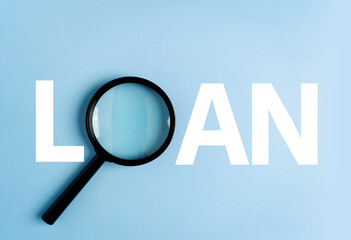 Loan word created with magnifying glass on blue backgroundใ - obrazy, fototapety, plakaty