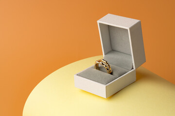 White jewelry box on yellow studio background