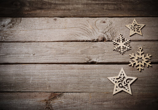 wooden snowflakes and srars on old dark background