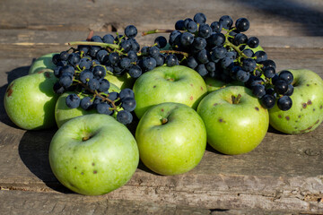 grapes and apples on a wooden table