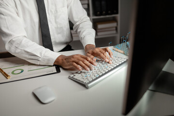 A businessman is looking at the financial growth data of the company, he is checking the data for development and improvement. Start-up company management concepts.