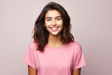 Fototapeta premium woman with pleasant smile, dark hair, dressed in casual pink t-shirt, white background