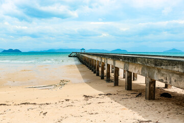 Pier against the backdrop of a beautiful azure bay in a transparent sea, vacation, travel, dream. Copy space.