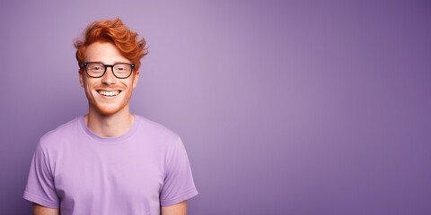 Handsome ginger man wearing purple t-shirt and glasses. Isolated on purple background.