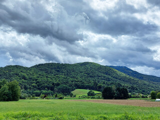 dark gray clouds over green Pohorje Mountains. Slovenia. Sky before storm