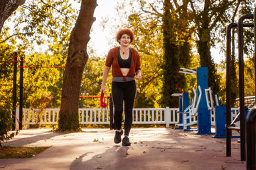 Adult Caucasian pretty woman active training in autumn city park. Healthy lifestyle