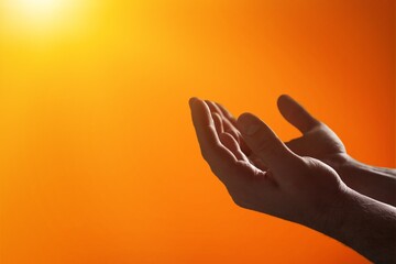 Hand praying on light yellow background.