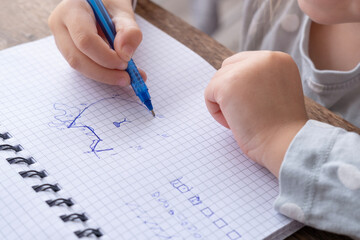 4-year-old Child drawing graphic dictation in checkered notebook, Connecting dots into picture, Motor Skill Improvement, Child's Creative Development, Creative Approach to Education