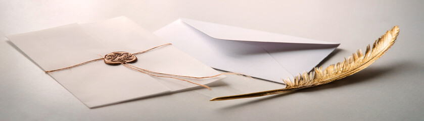 Golden pen and stamped envelope