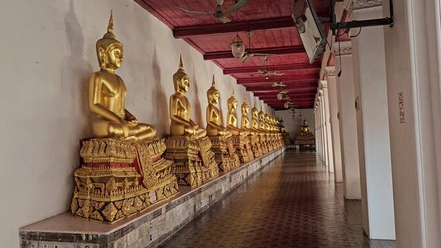 Ancient Buddha Images in Cloister at Wat Mahathat Yuwaratrangsarit Temple. It is a Famous Landmark of Bangkok, Thailand.