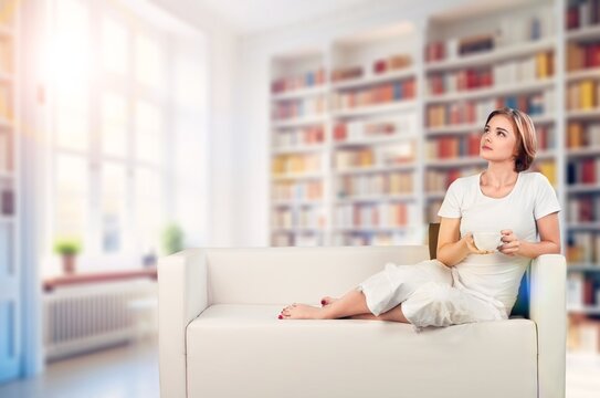 Young relaxed pretty woman sitting at home, AI generated image