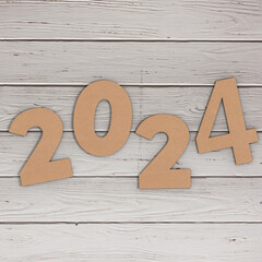 Cardstock Numbers 2024 Happy New Year Sign over table. 3d Rendering