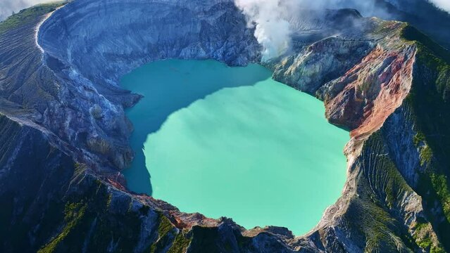 Aerial view of Kawah Ijen volcano with turquoise sulfur water lake at sunrise.Amazing nature landscape view at East Java, Indonesia. Natural landscape background