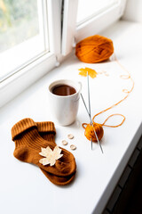 Set for knitting children's socks. Orange threads, knitting needles, buttons, centimeter.