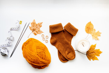 Set for knitting children's socks. Orange threads, knitting needles, buttons, centimeter.