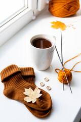 Set for knitting children's socks. Orange threads, knitting needles, buttons, centimeter.