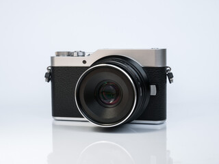 Camera in retro style on a white background with reflection