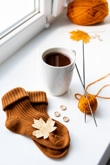 Set for knitting children's socks. Orange threads, knitting needles, buttons, centimeter.